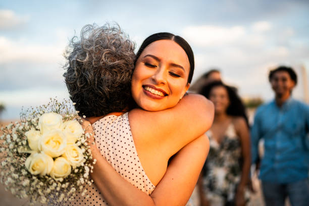 istock Bride embracing her grandmother after wedding ceremony on the beach 1933374856