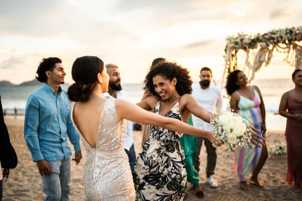 istock Bride celebrating with her friend at beach wedding party 1933375030