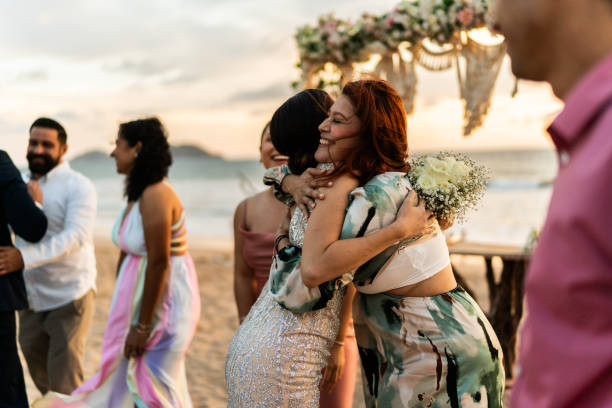 istock Bride embracing her friends after wedding ceremony on the beach 1933375179