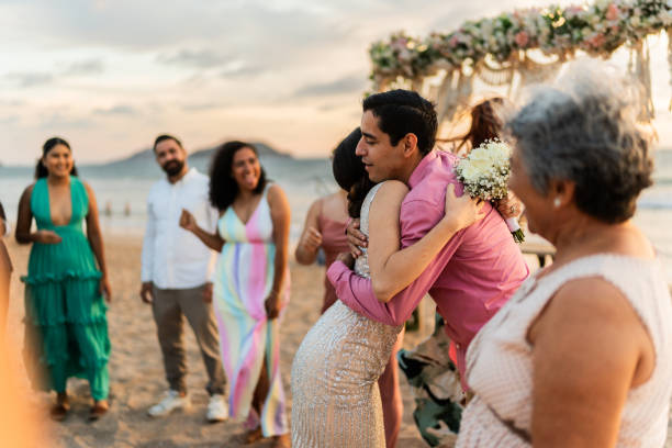 istock Bride embracing her friends after wedding ceremony on the beach 1933375180