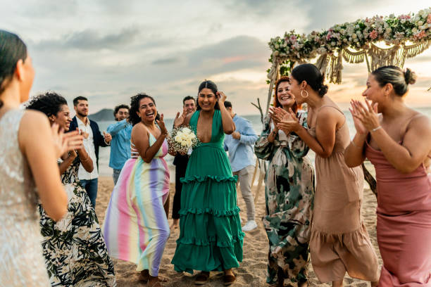 istock Bride's friends having fun on the beach wedding party 1933376764