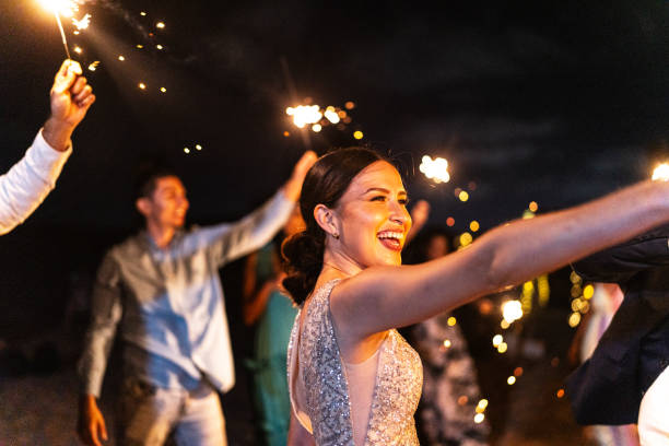 istock Bride playing with sparklers on the beach wedding party 1933378888