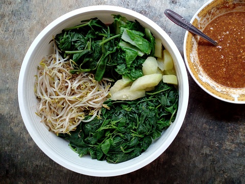 Vegetables such as spinach, kale, cucumber, cucumber krai and bean sprouts. Boiled vegetables served with peanut sauce. Indonesian food.