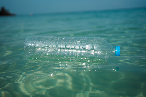 Plastic bottle floating in the ocean water.