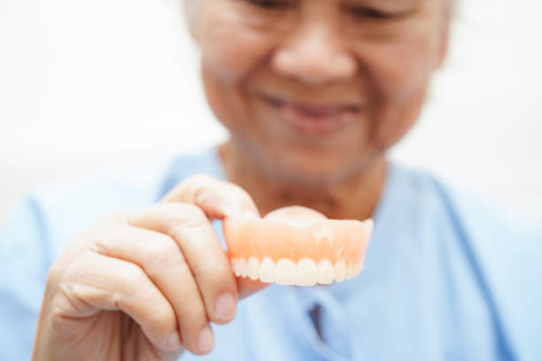 istock Doctor holding teeth denture in hand for dentist studying about dentistry. 1933484633
