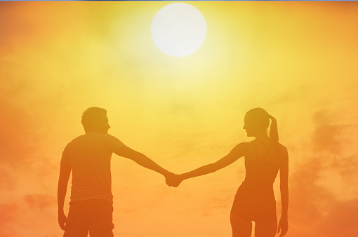 Asian middle aged couple standing at coast on a sunny, Koh Mak Thailand