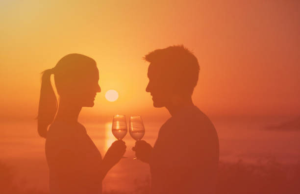 istock Cheers with wine glasses in a beautiful sunset beach. 1933501367