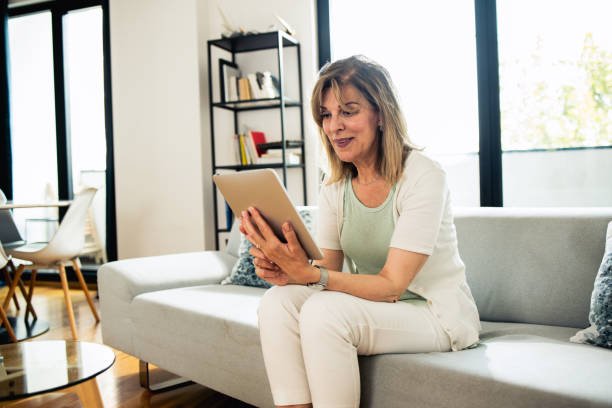 istock Shot of a mature woman using her digital tablet 1933549011