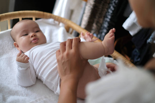 istock Unrecognizable Mother Wiping Her Baby’s Bottom 1933556181