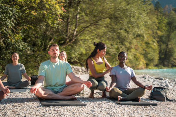 istock Peaceful Yoga Gathering by the River with Indian Instructor 1933556204