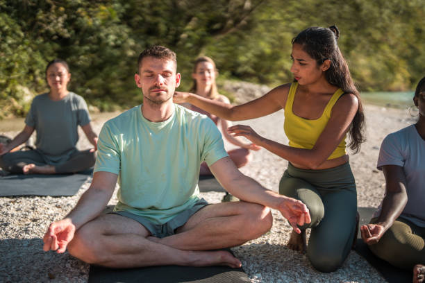 istock Peaceful Yoga Gathering by the River with Indian Instructor 1933556713
