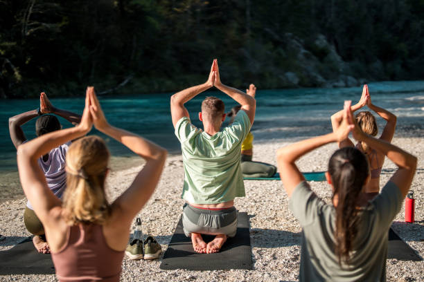 istock Sunny Outdoor Yoga with Diverse Group 1933556717
