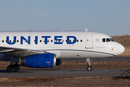 Denver, Colorado, USA - December 28, 2023: A United Airlines Airbus A319 taxies to the gate after landing at Denver International Airport.