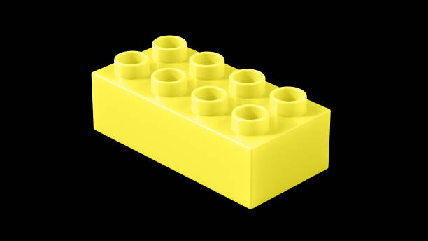 istock Lemon Plastic Toy Block Isolated on a Black Background. 1933566665