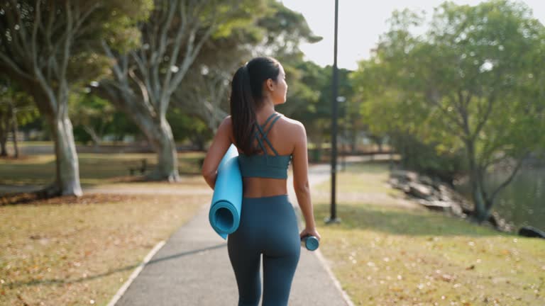 Young Asian woman exercise and training yoga at public park