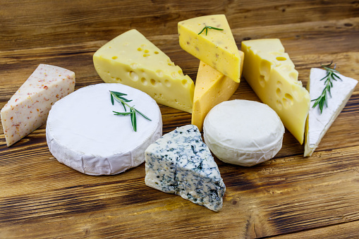 Set of various types of cheese on wooden table