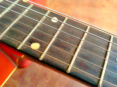 Fingerboard and strings on a guitar neck