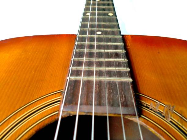 istock Fingerboard and strings on the guitar body with guitar holes 1933645827