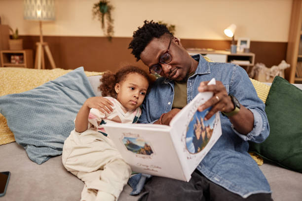 istock Father Reading Fairy Tale with Preschool Daughter 1933646387