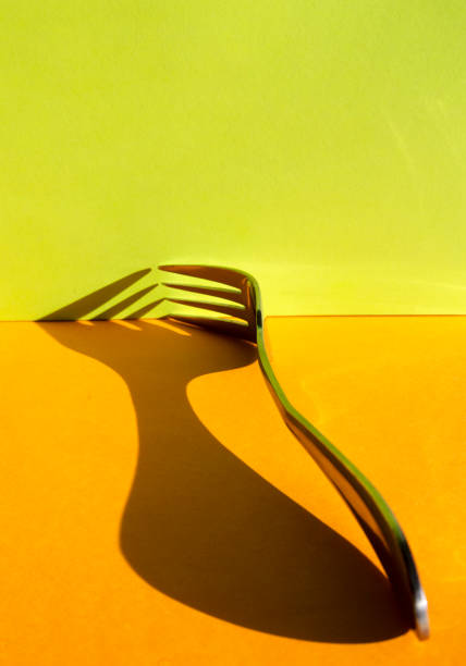 Close up of fork and reflection on black background