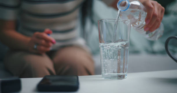 istock Young Asian woman drinking clean water 1933739579