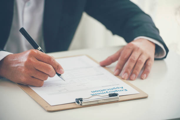 istock Businessman hand using pen signing on new contract starting projects in conference room. Close up business manager man hands sign contract legal document in meeting room. Business agreement concept 1933783208