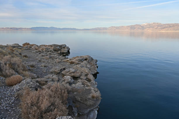 Rock formations and reflections of Pyramid Lake, Nevada on clear tranquil winter afternoon.