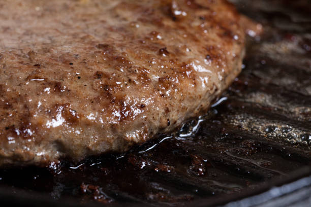 istock beef burger on metal pan 1933790658