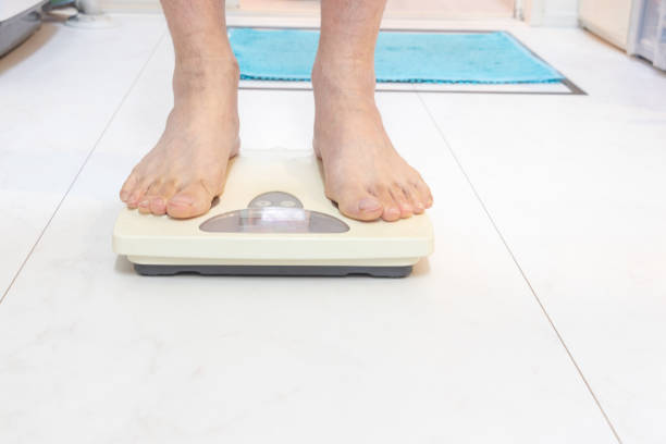 istock A person weighs himself after taking a bath 1933807595