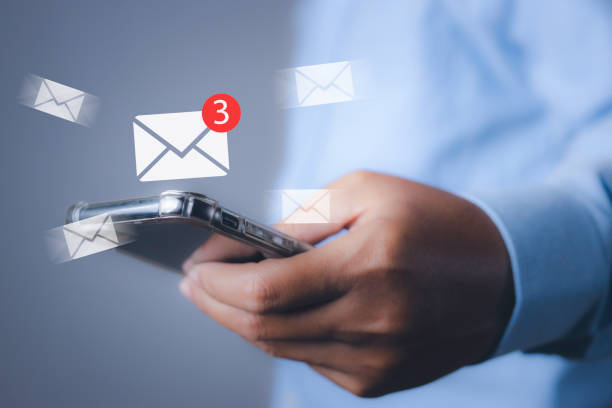 istock Businessman using smartphone with new email notification for business e-mail communication and digital marketing. Inbox receiving electronic message alert internet technology. 1933915863