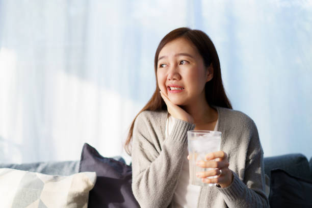 istock Woman drinking a cold water and got toothache. 1933917416