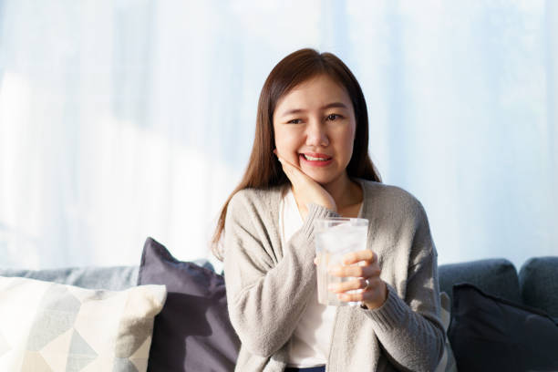 istock Woman drinking a cold water and got toothache. 1933917417