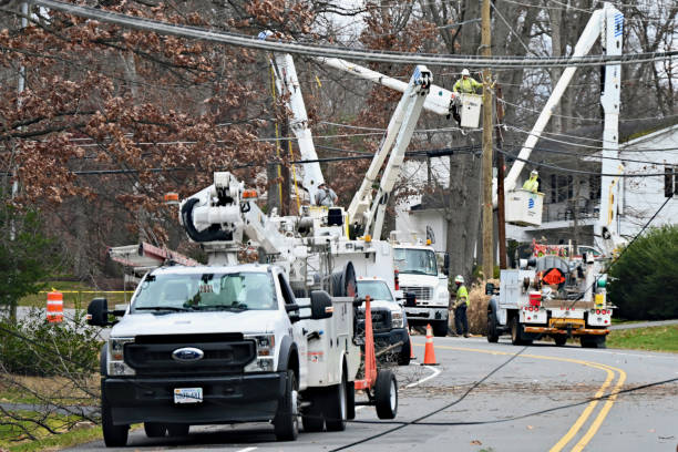 Dominion Energy Crews Repair Storm-Damaged Power Lines, Fairfax, Virginia (USA) Fairfax, Virginia, USA - January 10, 2024: Several crews from Dominion Energy work together to restore power to a suburban neighborhood following damage to power lines caused by high winds and rains the night before. truck in rain stock pictures, royalty-free photos & images