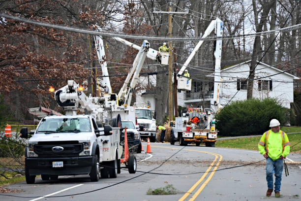 Dominion Energy Crews Repair Storm-Damaged Power Lines, Fairfax, Virginia (USA) Fairfax, Virginia, USA - January 10, 2024: Several crews from Dominion Energy work together to restore power to a suburban neighborhood following damage to power lines caused by high winds and rains the night before. truck rain stock pictures, royalty-free photos & images