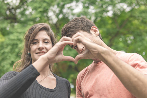 istock Couple holding hands making a heart 1933947459