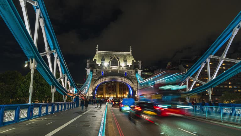 4K Footage Time lapse of Crowded Commuter people walking on the Tower Bridge riverbank can see the office in downtown district of London,England, United Kingdom