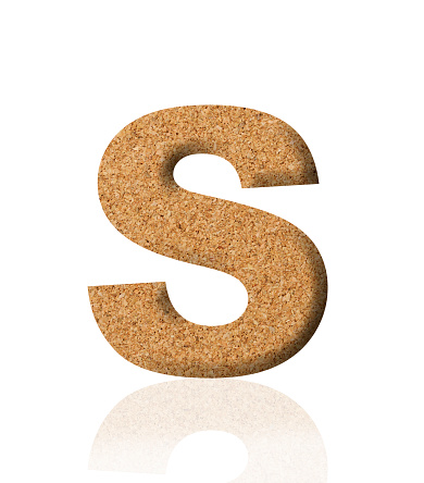Close-up of three-dimensional cork alphabet letter S on white background.