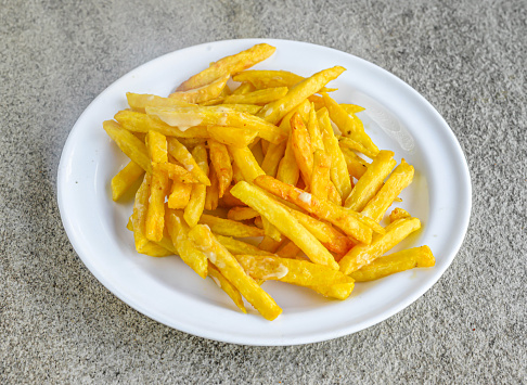 Regular Plain Fries served in dish isolated on grey background side view of indian spices and pakistani food