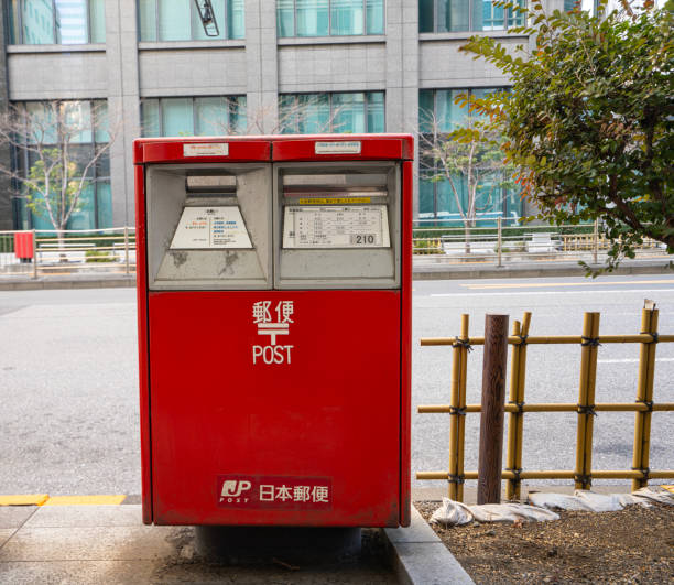 Tokyo, Japan, January 2024. a Japanese post mailbox on the sidewalk of a city center street