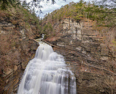 Afternoon winter photo of Lucifer Falls waterfall in Robert H. Treman State Park near Ithaca NY, Tompkins County New York.  (01-13-2024)