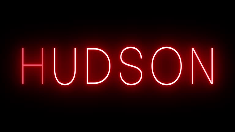 Glowing and blinking red retro neon sign for HUDSON