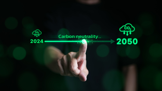 Carbon neutrality concept. Hand touching increasing arrow with carbon reduction for decrease CO2 or carbon neutral by 2050. Carbon footprint, Net Zero, Climate change, Global warming, CO2 emissions,