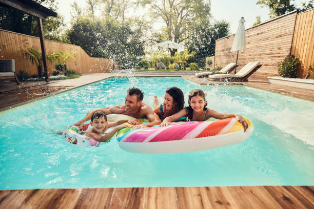 istock Cheerful family having fun during summer day in the pool. 1934160923