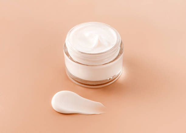 istock cream jar cosmetic smear cream texture on pastel beige background 1934167699