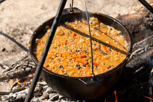 istock Cooking pilaf over a campfire in a tent camp, rice, carrots, spices, mutton 1934170815