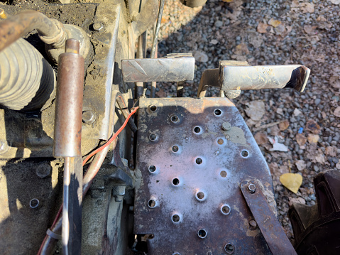 Tractor metal brake pedals and handbrake closeup