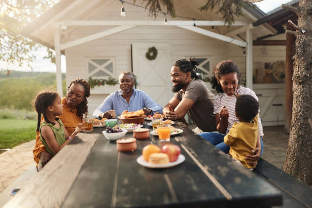 istock Happy black extended family talking while having a meal at patio. 1934186475