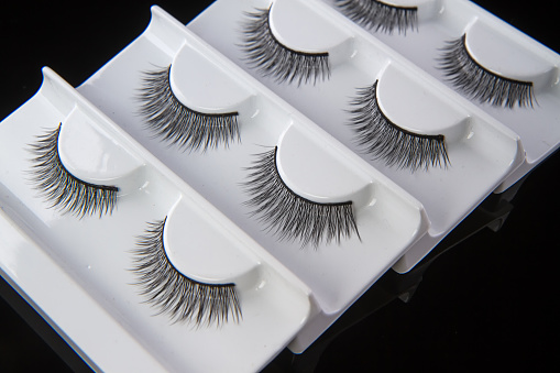 Fashion fake false eyelash set isolated on black background