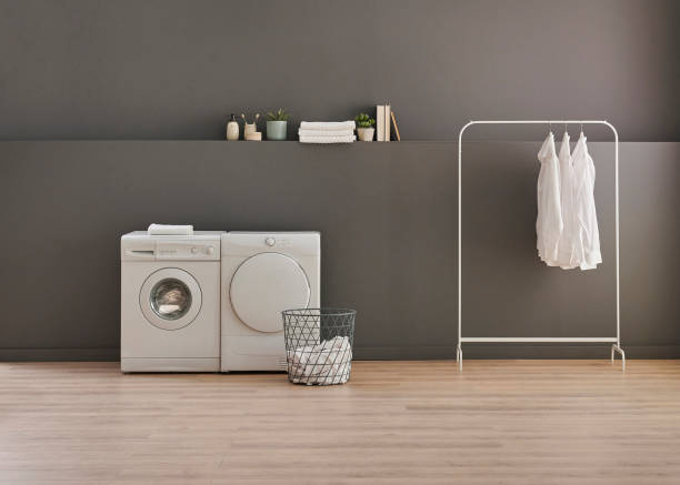 istock Washing and drier machine in the grey wall room background, laundry, clothe, sofa and working table style, minimalist home interior. 1934208296