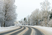 Car road in the snow in frosty winter weather.